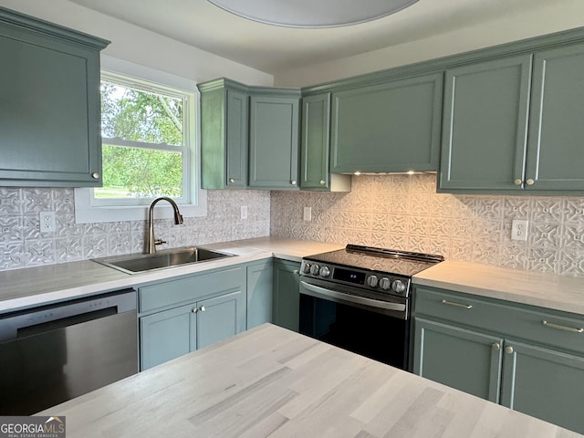 101 Newsome St, Union Point, GA 30669 - kitchen featuring stainless steel appliances, a sink, and green cabinetry