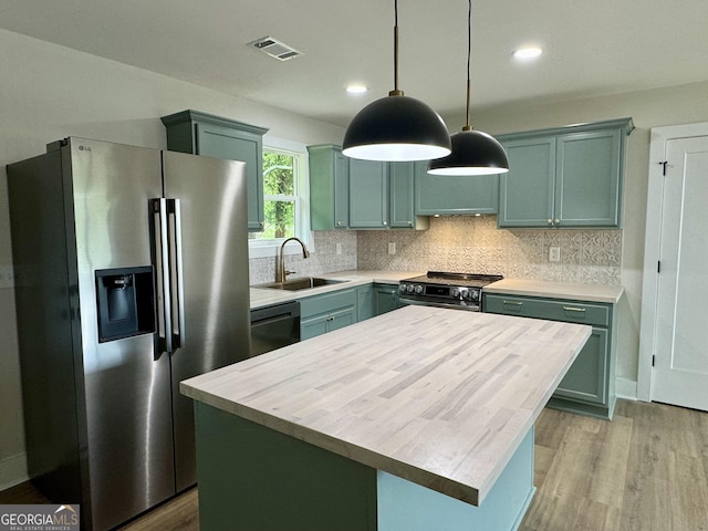101 Newsome St, Union Point, GA 30669 - kitchen with stainless steel appliances, a sink, green cabinetry, light wood-style flooring, and recessed lighting