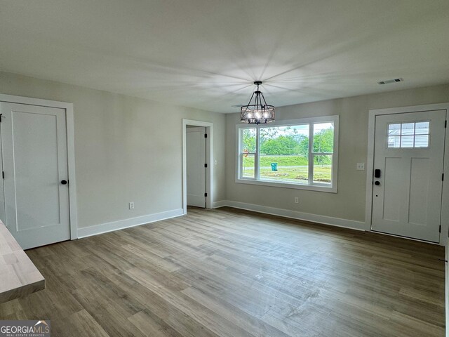 101 Newsome St, Union Point, GA 30669 - unfurnished dining area with a chandelier, plenty of natural light, baseboards, and wood finished floors