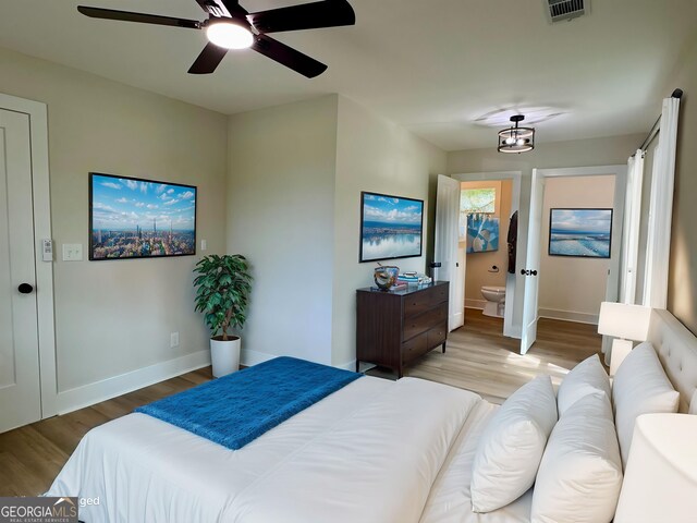 101 Newsome St, Union Point, GA 30669 - bedroom with wood finished floors, baseboards, and connected bathroom