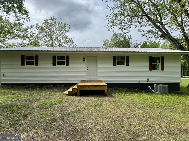 101 Newsome St, Union Point, GA 30669 - back of house with metal roof, a yard, and central AC unit