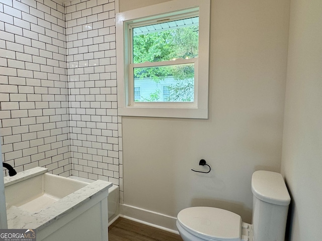 101 Newsome St, Union Point, GA 30669 - full bathroom with toilet, wood finished floors, baseboards, and shower / washtub combination