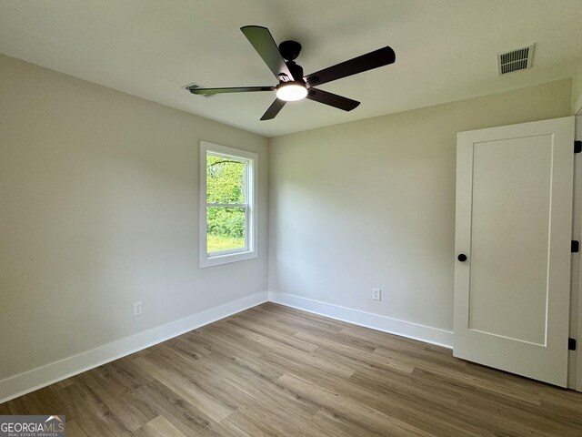 101 Newsome St, Union Point, GA 30669 - empty room featuring a ceiling fan, wood finished floors, and baseboards