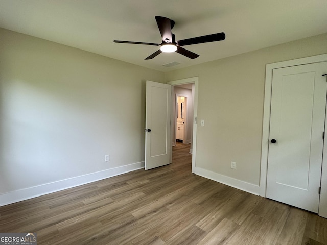 101 Newsome St, Union Point, GA 30669 - unfurnished bedroom with wood finished floors, baseboards, and ceiling fan