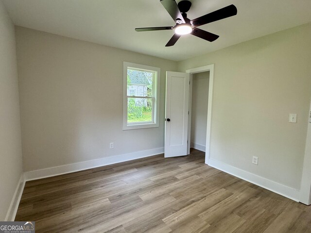101 Newsome St, Union Point, GA 30669 - unfurnished bedroom with wood finished floors, baseboards, and ceiling fan