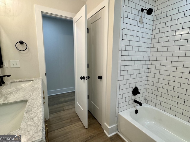 101 Newsome St, Union Point, GA 30669 - bathroom with wood finished floors, washtub / shower combination, double vanity, and baseboards