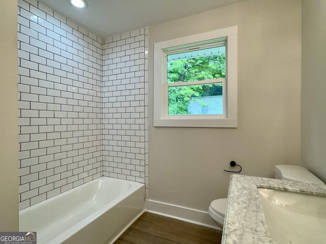 101 Newsome St, Union Point, GA 30669 - bathroom featuring toilet, wood finished floors, a sink, baseboards, and tub / shower combination