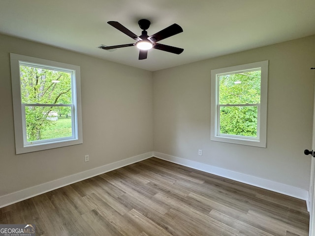 101 Newsome St, Union Point, GA 30669 - empty room with wood finished floors, baseboards, and ceiling fan