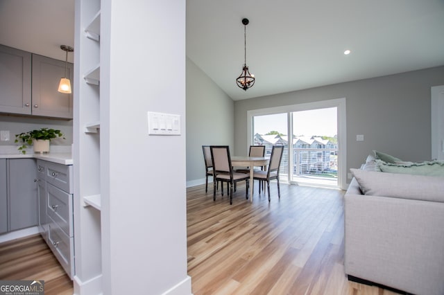 dining space with baseboards, recessed lighting, light wood-style flooring, and vaulted ceiling