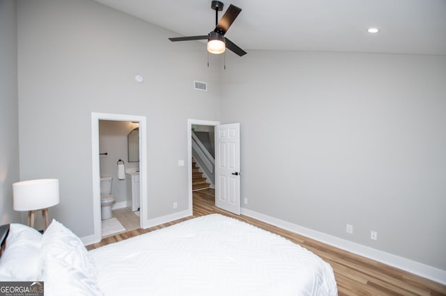 bedroom featuring visible vents, high vaulted ceiling, light wood-style flooring, and baseboards