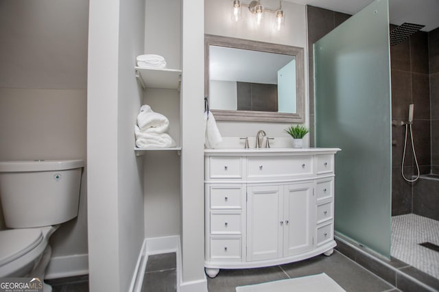 bathroom featuring baseboards, tiled shower, toilet, and vanity
