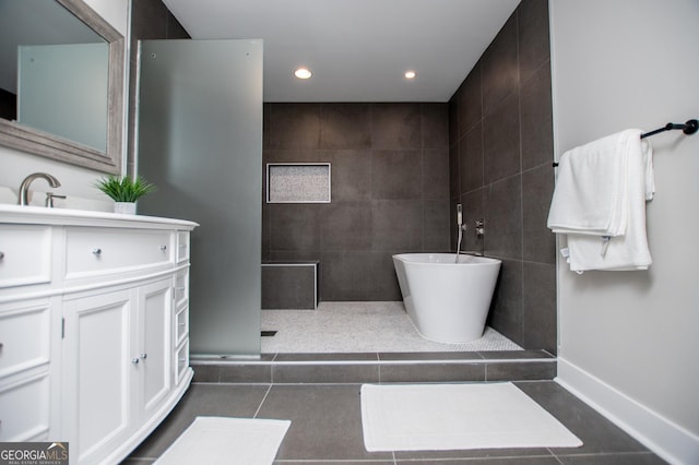 full bath featuring recessed lighting, tile patterned floors, a walk in shower, vanity, and a freestanding bath