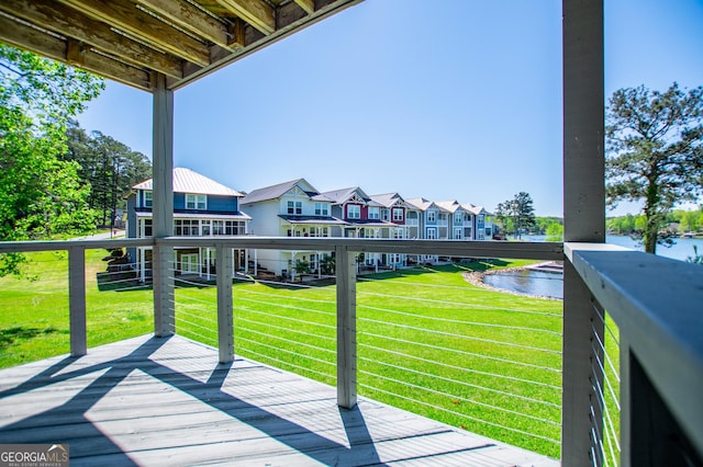 balcony with a residential view and a water view