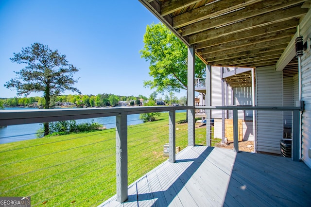 deck featuring a lawn and a water view
