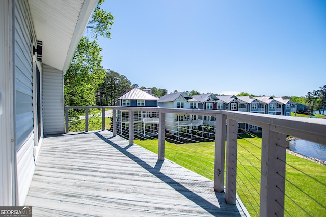 deck featuring a residential view and a lawn