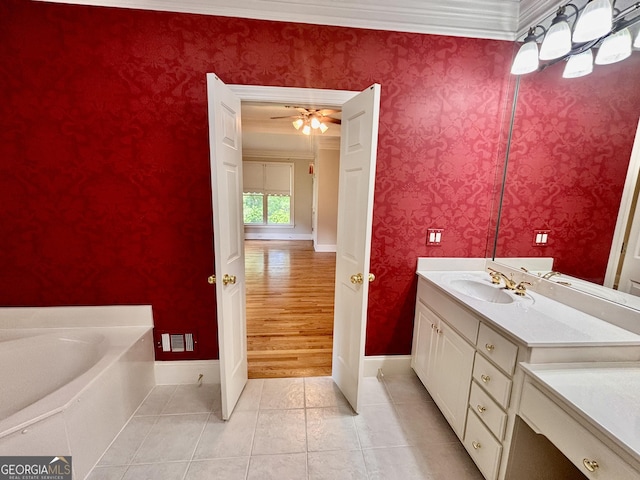 bathroom featuring baseboards, tile patterned floors, ornamental molding, and vanity