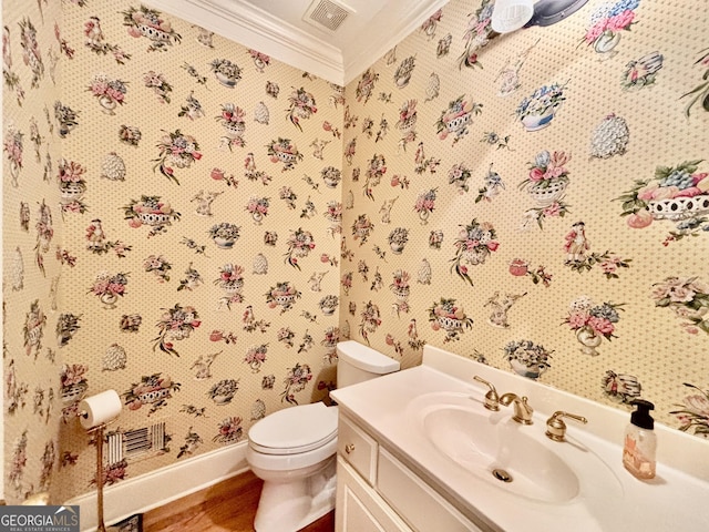 half bathroom with wood finished floors, wallpapered walls, baseboards, visible vents, and crown molding