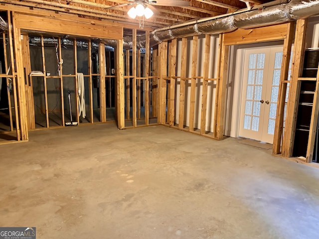 miscellaneous room featuring concrete flooring and french doors