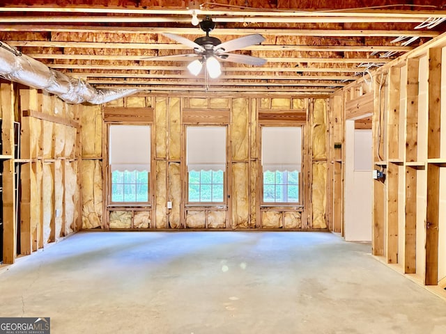misc room featuring unfinished concrete floors and a ceiling fan