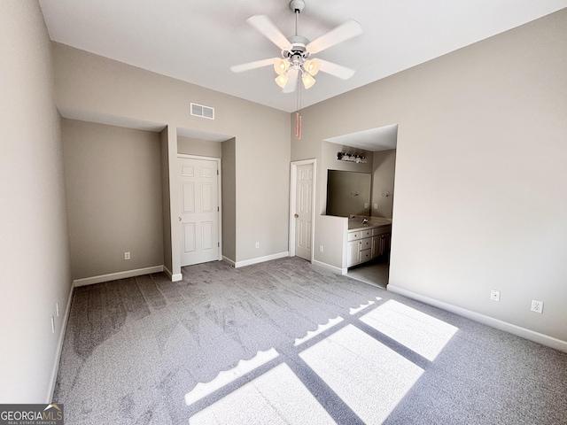 unfurnished bedroom featuring visible vents, connected bathroom, baseboards, and carpet floors