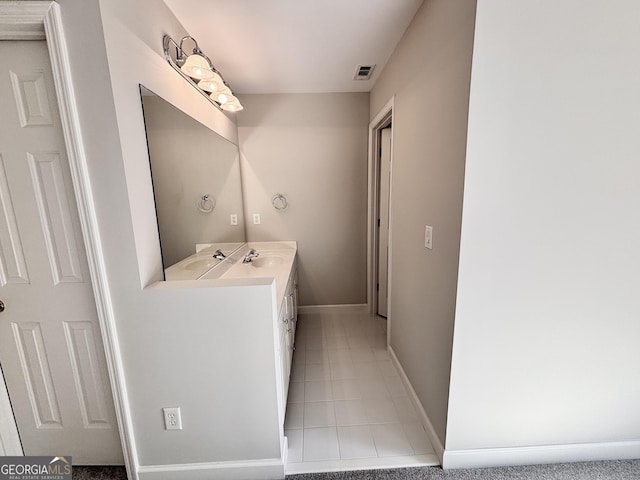 bathroom with tile patterned floors, visible vents, double vanity, and a sink