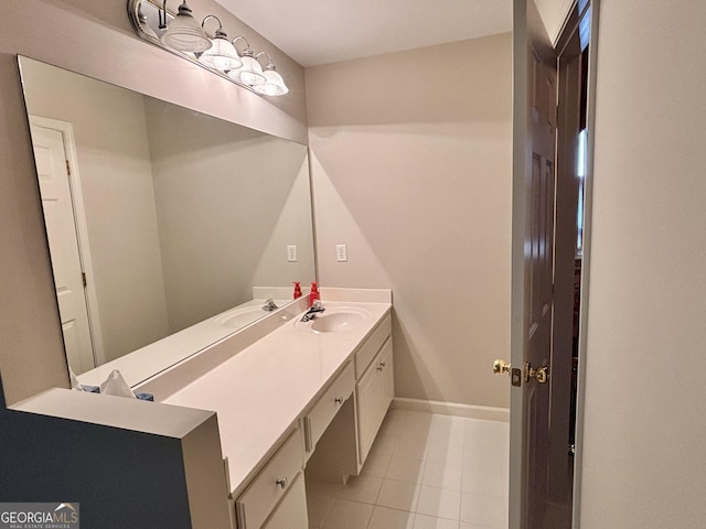bathroom with tile patterned floors, vanity, and baseboards