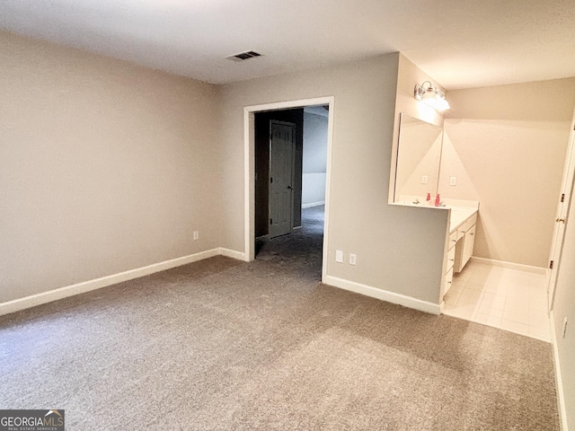 unfurnished bedroom with baseboards, visible vents, and carpet flooring
