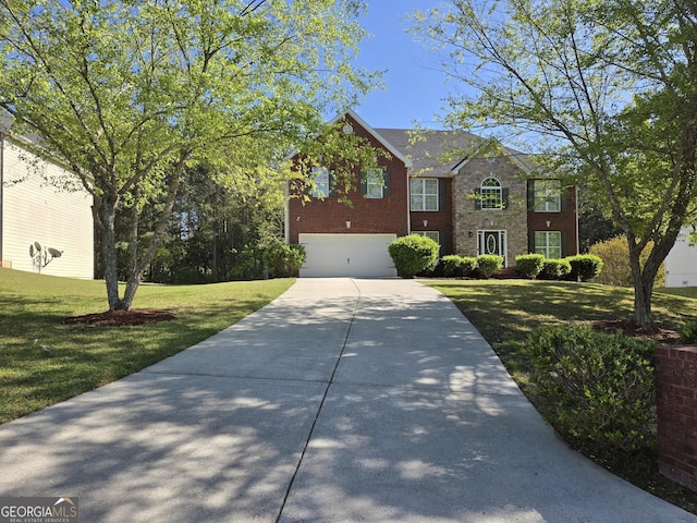 view of front of home featuring driveway, a front yard, brick siding, and a garage