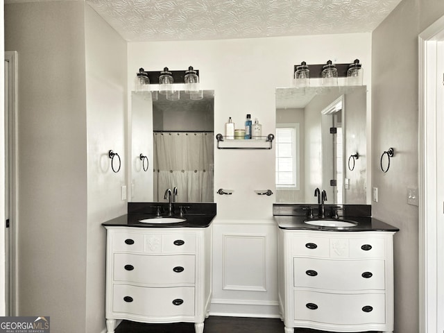 full bathroom featuring two vanities and a sink