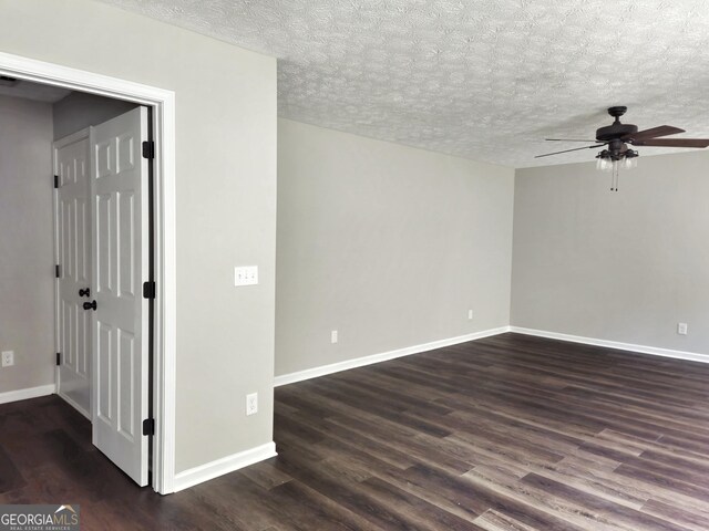 spare room with dark wood-style floors, baseboards, and ceiling fan