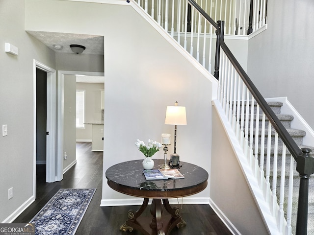 stairs with wood finished floors and baseboards