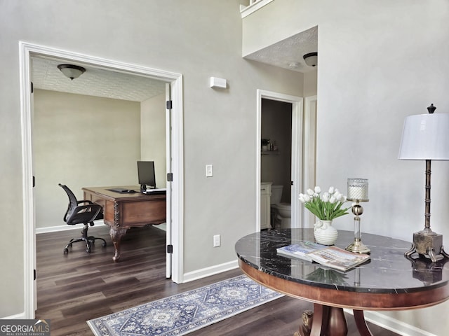 home office featuring wood finished floors and baseboards