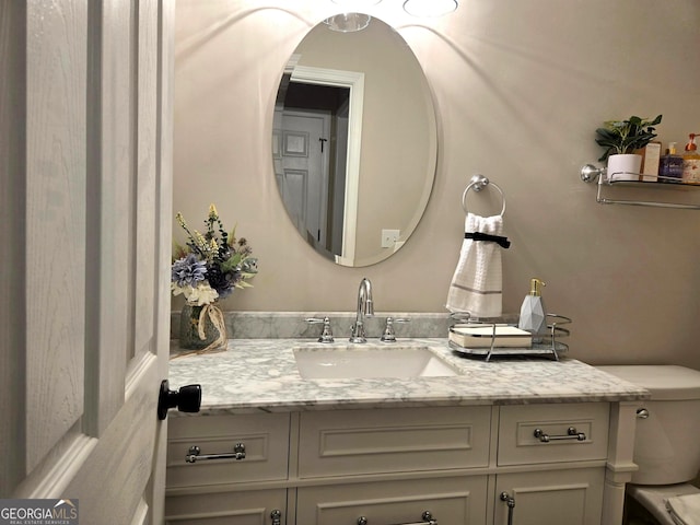bathroom featuring toilet and vanity