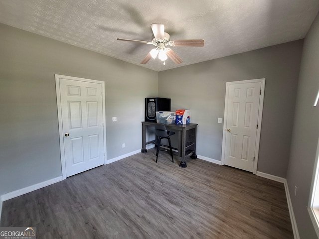 office area with baseboards, wood finished floors, a ceiling fan, and a textured ceiling