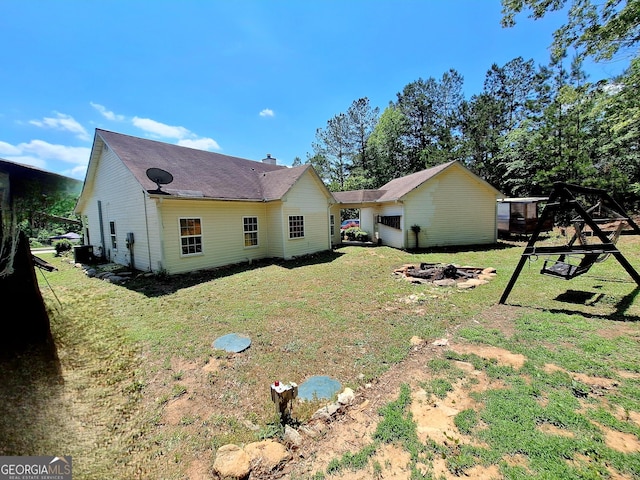back of house with a lawn