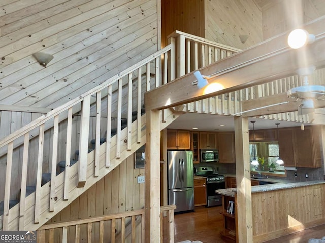 296 Fairview Ct, Jasper, GA 30143 - staircase featuring wood finished floors, a high ceiling, and wooden walls