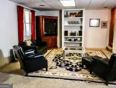 296 Fairview Ct, Jasper, GA 30143 - living room featuring baseboards and a drop ceiling