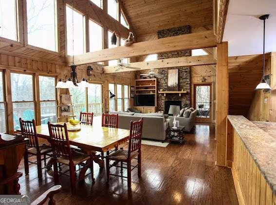 296 Fairview Ct, Jasper, GA 30143 - dining room featuring plenty of natural light, wood walls, dark wood finished floors, and high vaulted ceiling