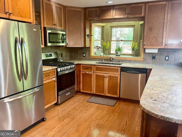 296 Fairview Ct, Jasper, GA 30143 - kitchen with a sink, tasteful backsplash, stainless steel appliances, and light wood-type flooring