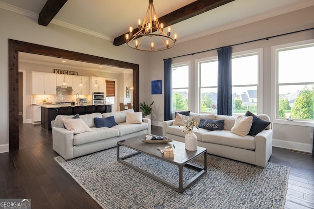 living room featuring dark wood finished floors, baseboards, beamed ceiling, a chandelier, and ornamental molding