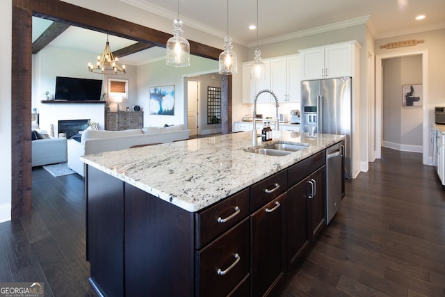 kitchen featuring light stone counters, a sink, white cabinetry, recessed lighting, and stainless steel appliances