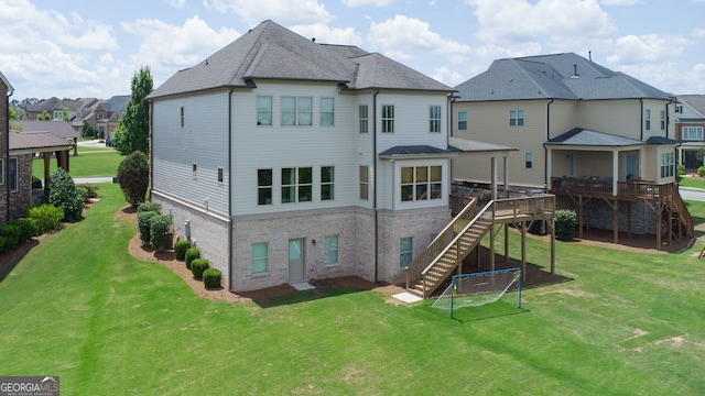 rear view of house with a residential view, a deck, a yard, and stairway
