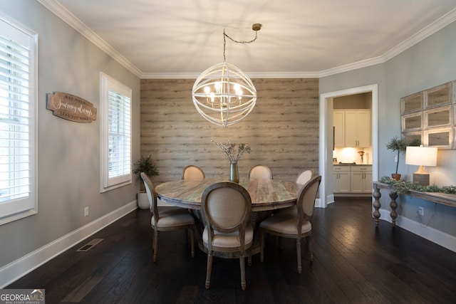 dining area with visible vents, an accent wall, baseboards, a chandelier, and dark wood finished floors