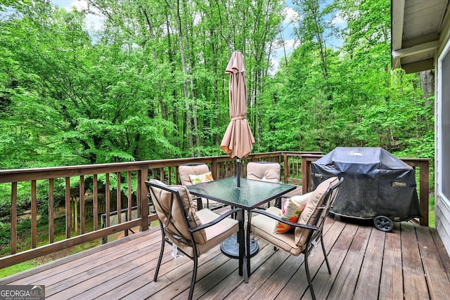 wooden terrace featuring outdoor dining area and a grill