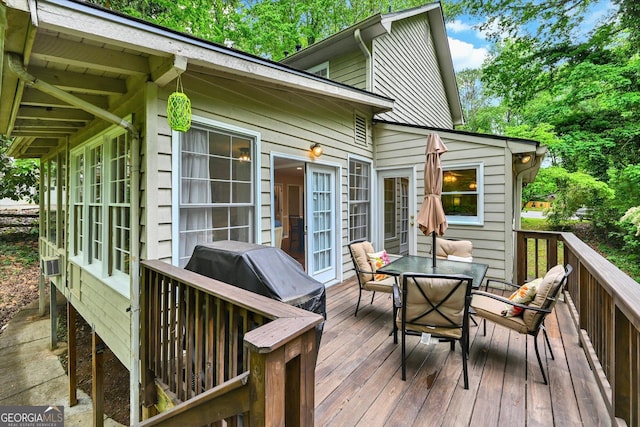 wooden terrace with outdoor dining area