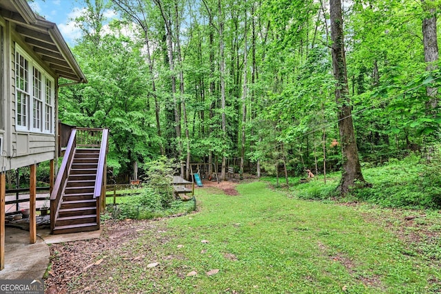 view of grassy yard featuring stairs