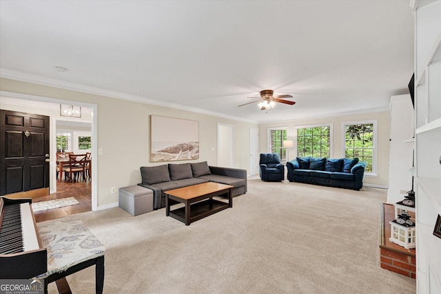 living area with a ceiling fan, a brick fireplace, baseboards, light colored carpet, and ornamental molding