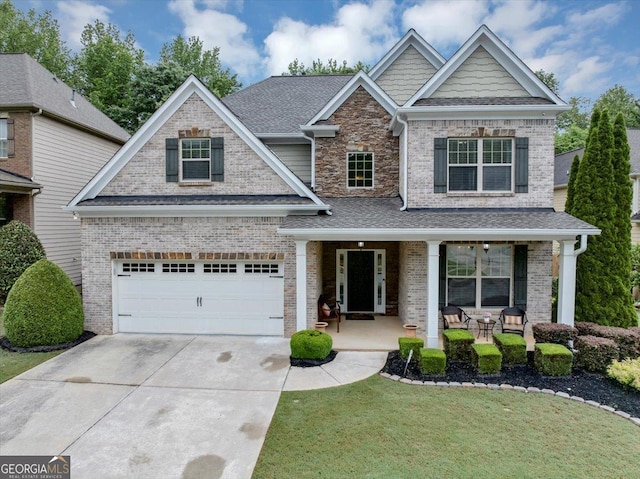 2376 Roberts View Trl, Buford, GA 30519 - craftsman inspired home featuring covered porch, concrete driveway, brick siding, and a front yard