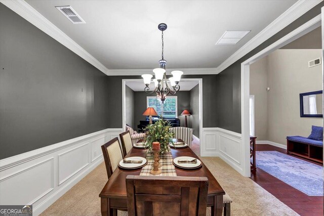 2376 Roberts View Trl, Buford, GA 30519 - carpeted dining area with visible vents, a decorative wall, ornamental molding, and a notable chandelier