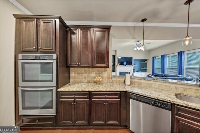 2376 Roberts View Trl, Buford, GA 30519 - kitchen with stainless steel appliances, light stone counters, dark brown cabinets, and a sink